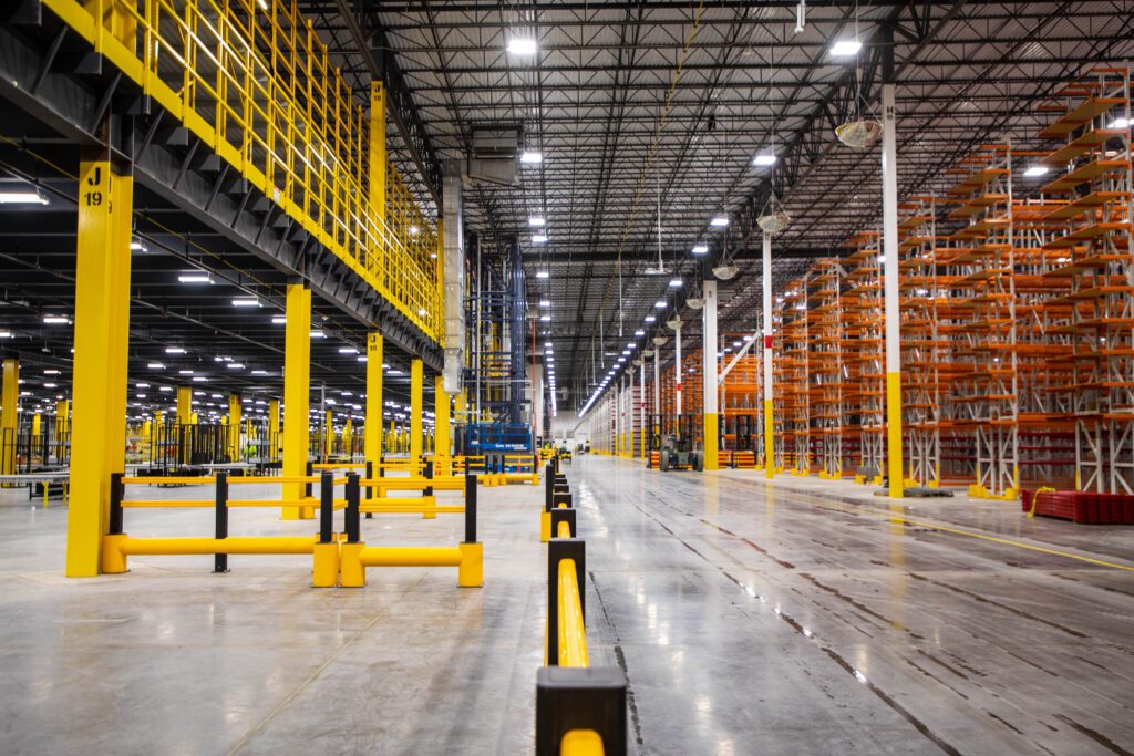 Well lit warehouse with yellow and orange beams.