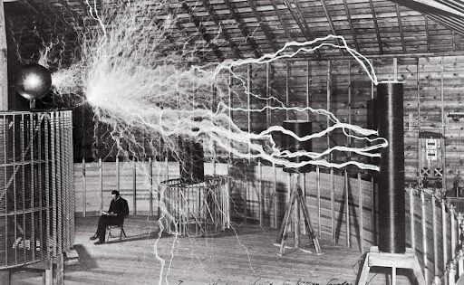 Nikola Tesla in a room with his alternating current motor