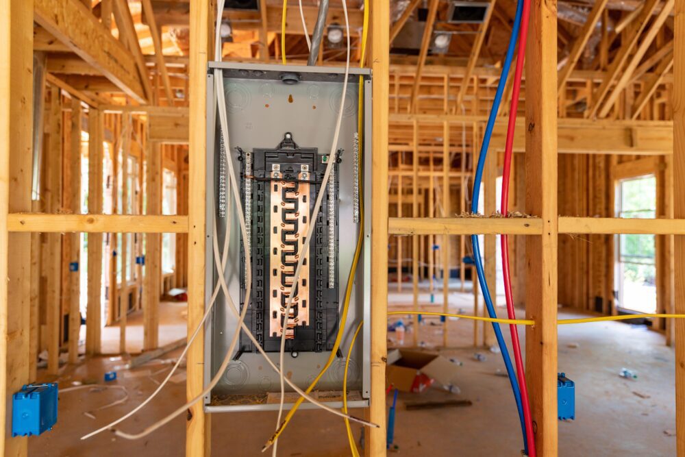 construction of inside of building with wooden framework and open electrical panel