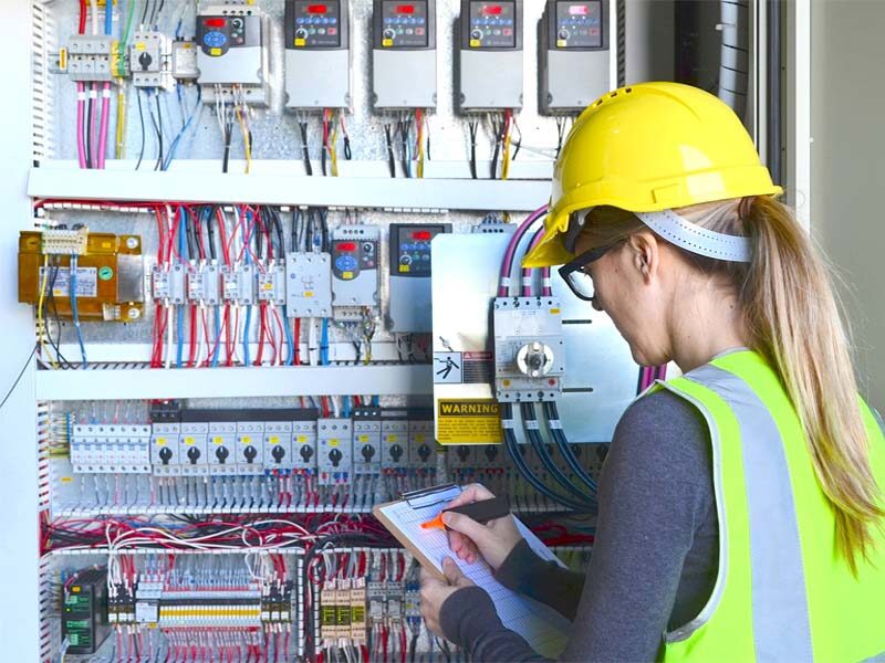 Women in Construction Week title with woman with hard hat and safety glasses