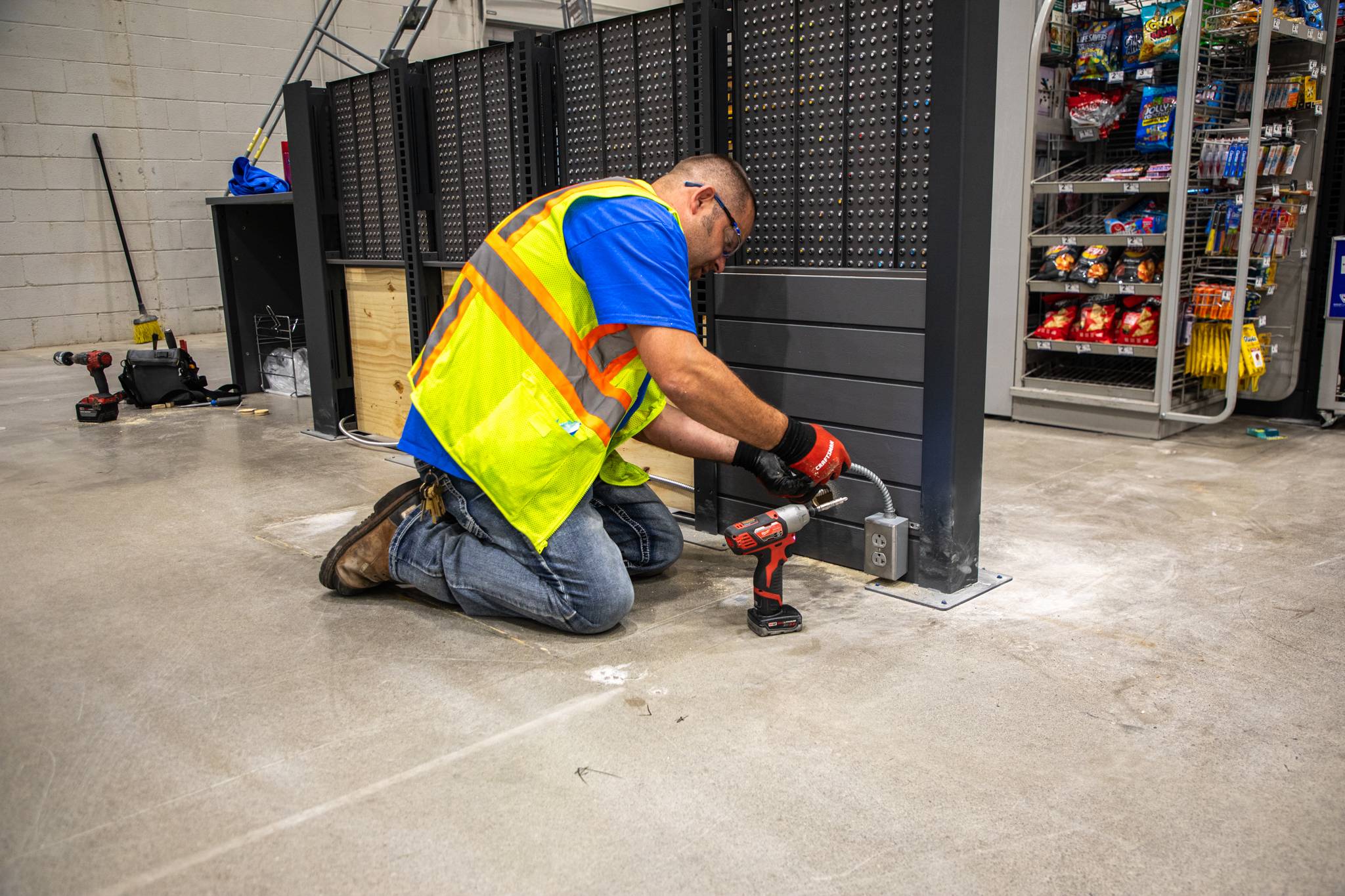 NHI - 2 Technician connecting to new power box before installing self-checkout machine.