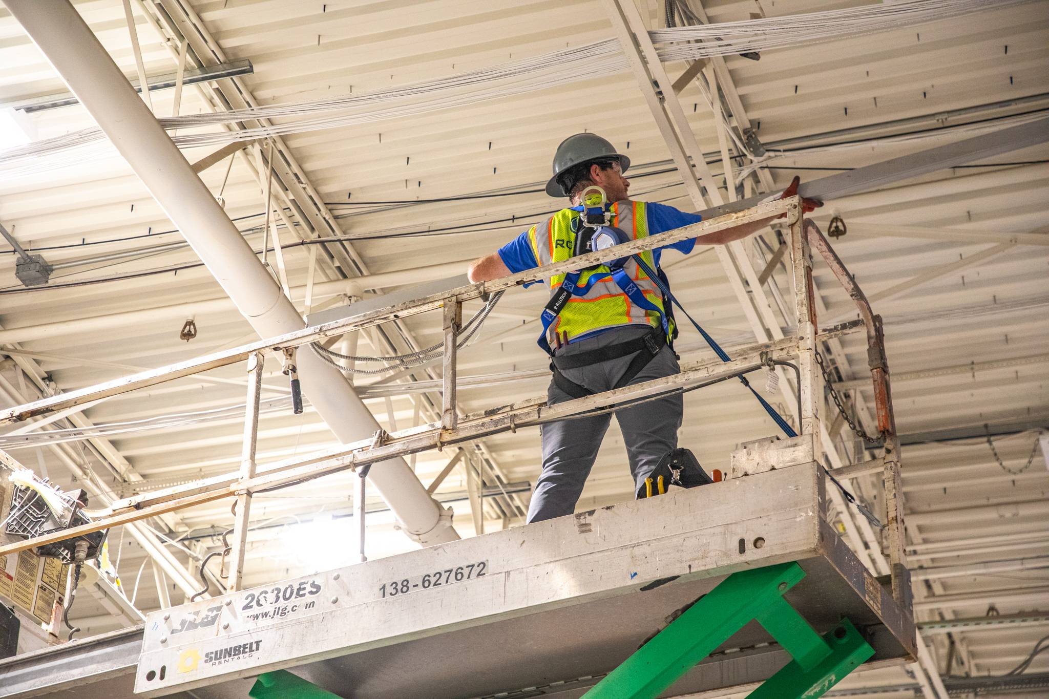 Tech on lift installing new power drop