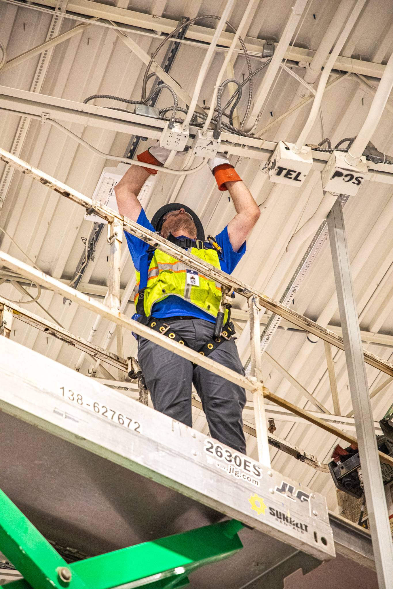 NHI - 1 Technician on lift preparing power box before adding new power pole.