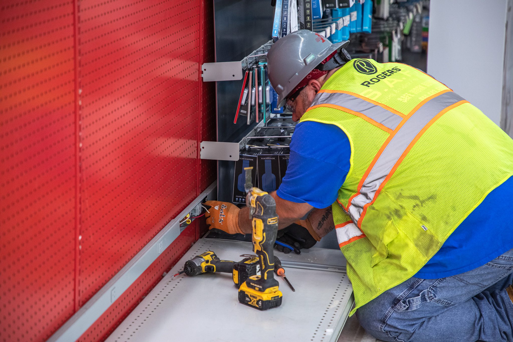 Technician removing wiring from gondolas.