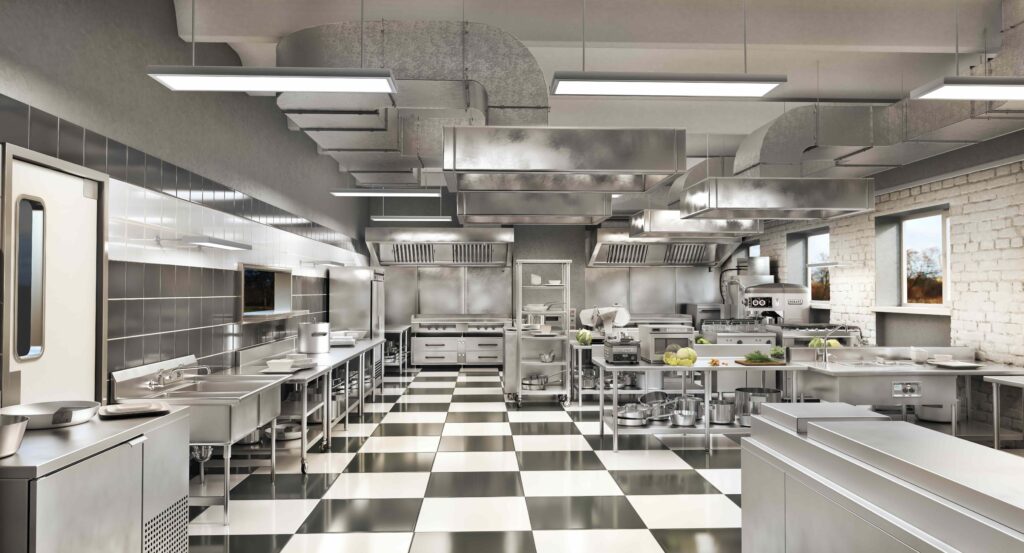 inside of commercial kitchen at a restaurant with checkered floors and stainless steel appliances