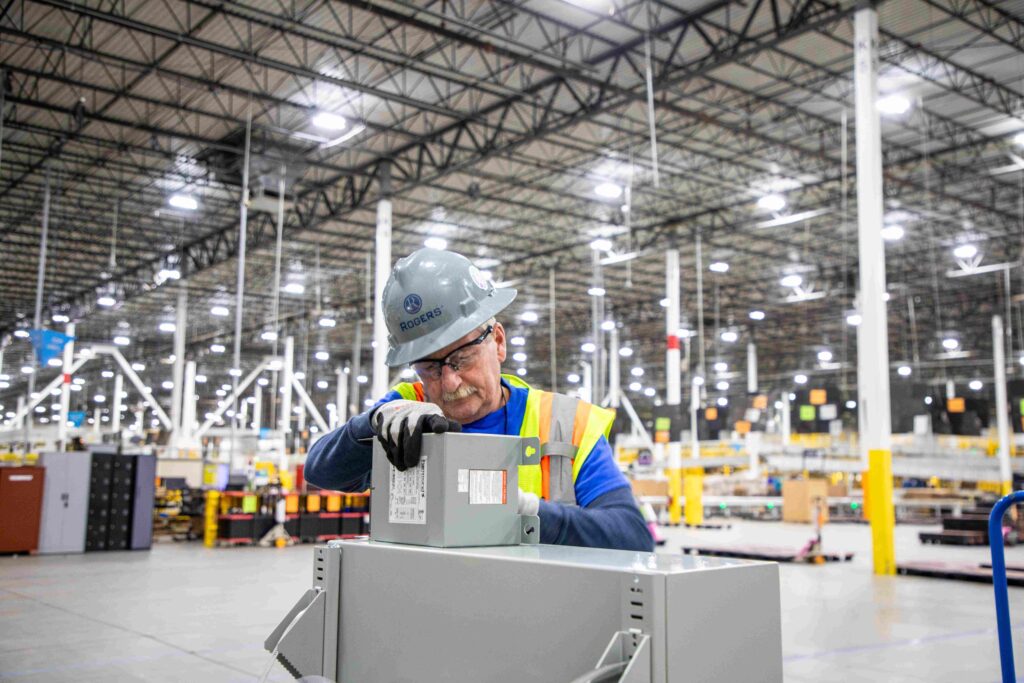 A commercial electrician working in a warehouse.