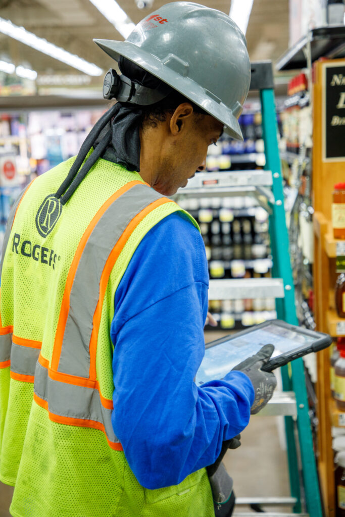 Commercial electrician reviewing an energy audit in a retail store.