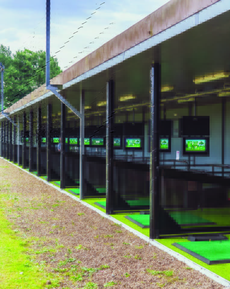 Trackman golf range with technology-driven training bays powered by electrical infrastructure.