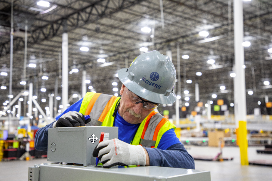 Electrician working on electrical equipment to support reliable building operations