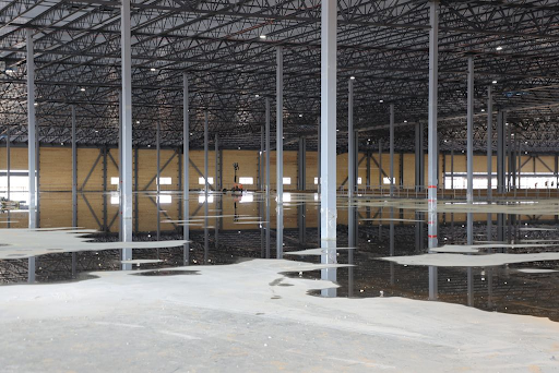 Flooded commercial facility showing the importance of protecting electrical systems from water damage through strategic design and storm resilience planning.